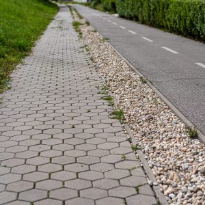 cobblestone-sidewalk-bike-path-are-separated-by-small-stones